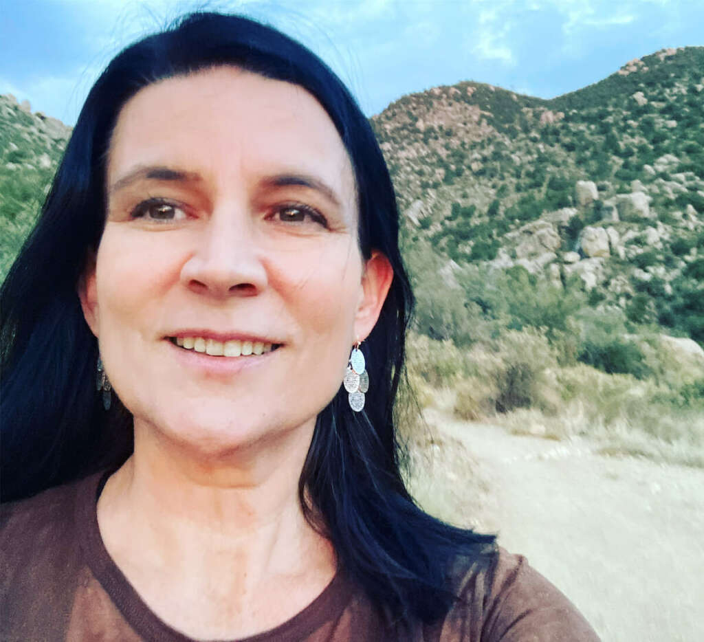 woman on top of mountains looking into the distance