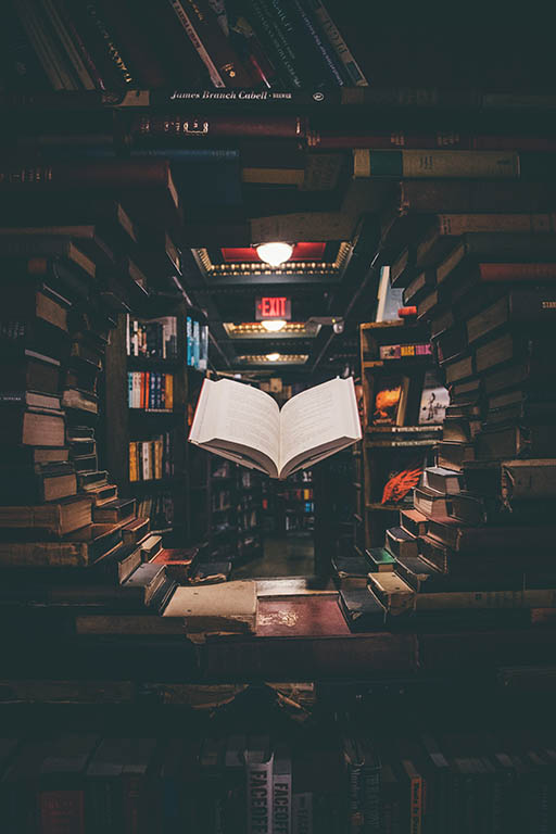magical book floating in library